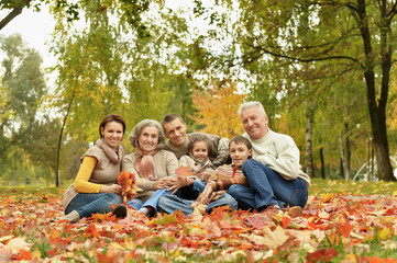 Fototapeta premium Portrait of family relaxing in autumn park
