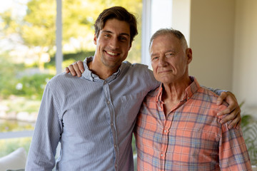 Fototapeta premium Father and son holding each other at home