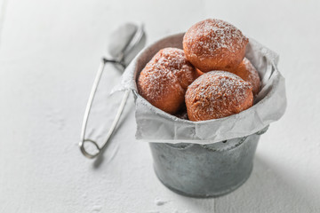 Sweet mini doughnuts hot in small bucket