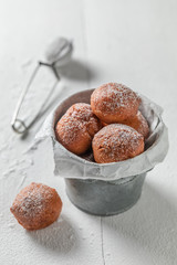 Mini doughnuts hot and freshly baked in small bucket