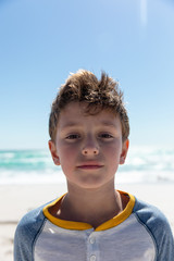 Boy looking at the camera at the beach