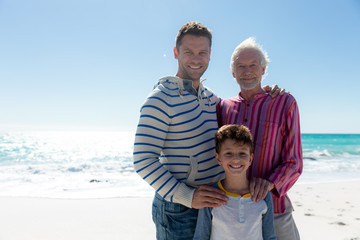 Fototapeta na wymiar Grandfather father and son at the beach