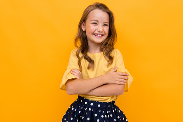 stylish charming young smiling girl in a light yellow blouse and skirt on a yellow background