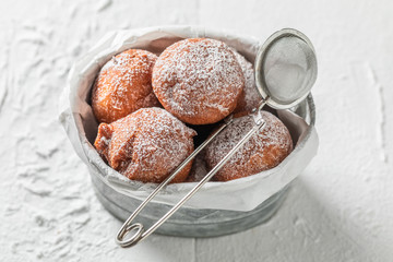 Topview of yummy and fresh donuts balls with powdered sugar