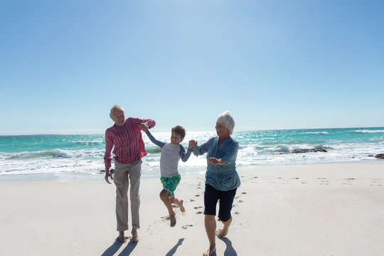 Grandparents And Grandson At The Beach