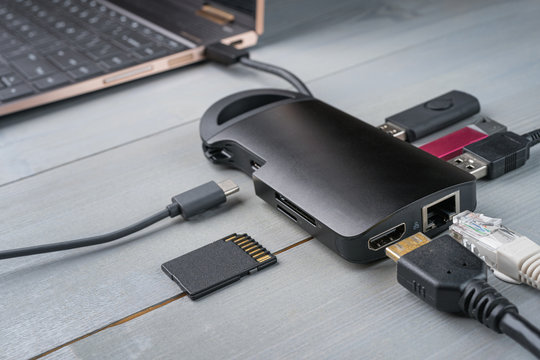 USB Type C adapter or hub with various accessories - pendrives, hdmi, ethernet, memory card, cables.