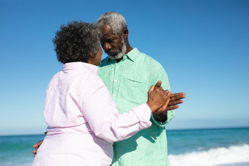 Old couple in love at the beach