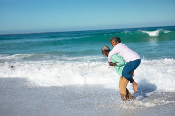 Old couple having fun at the beach