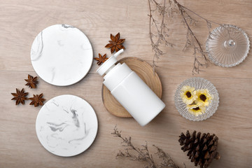 Cosmetic bottle containers packaging with green herbal leaves, Blank label for organic branding mock-up, Natural skincare beauty product concept.