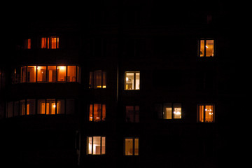 Glowing apartment windows at night where each occupant has his own privacy © Sergey