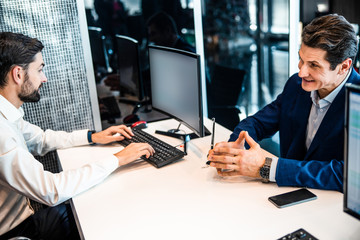 Smiling entrepreneur looking at a young man