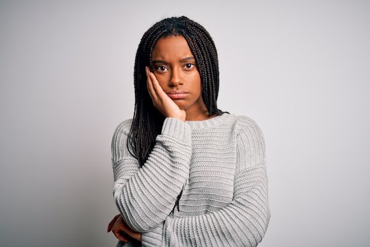 Young african american woman standing casual and cool over grey isolated background thinking looking tired and bored with depression problems with crossed arms.