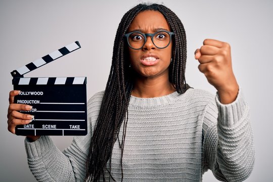 Young African American Director Girl Filming A Movie Using Clapboard Over Isolated Background Annoyed And Frustrated Shouting With Anger, Crazy And Yelling With Raised Hand, Anger Concept