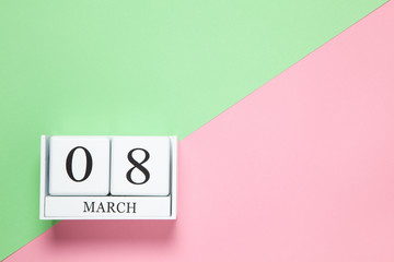 Fototapeta na wymiar Perpetual calendar with date of March 8 on two-color background pink and green. Flat lay. Top view. International Happy Women's Day celebration concept. Horizontal, close-up, copy spase. For delivery