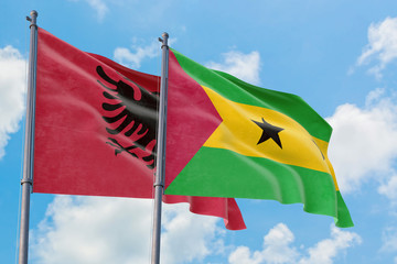 Sao Tome And Principe and Albania flags waving in the wind against white cloudy blue sky together. Diplomacy concept, international relations.