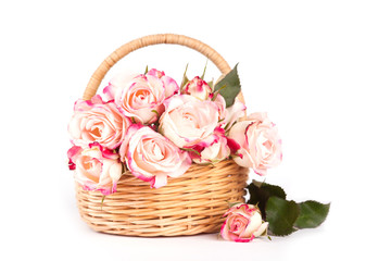 Beautiful pink roses in a wicker basket on a white background. Isolate Concept Valentine's Day, Mother's Day. Holiday gift.