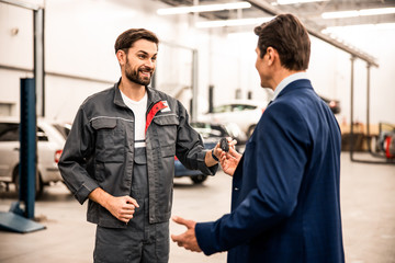Worker holding his clients car key fob