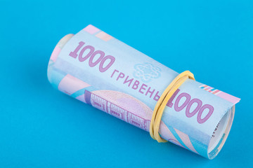 Fototapeta premium Ukrainian hryvnia, several banknotes of 1000 hryvnias. Financial background from Ukrainian banknotes. Banknotes are rolled up. Close-up