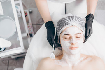 portrait of client in spa. Woman with true natural beauty, young brunette on a regular cosmetic procedure with her doctor