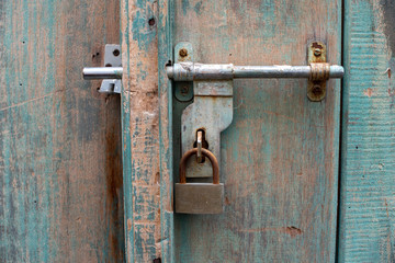 A vintage grunge lock on an old house gate
