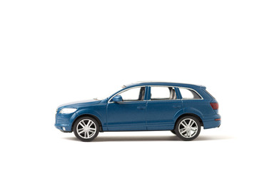 Fototapeta na wymiar Blue iron toy car on a white background. SUV. copy space. sport utility vehicle