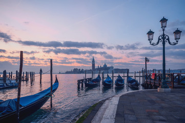 famous gondolas at sunrise. Venice, Italy. picture with long exposure