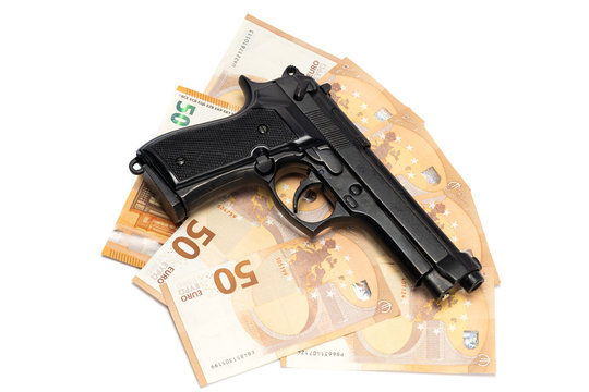Gun and money, isolated on white background. Financial Crime Concept.
