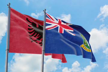 British Virgin Islands and Albania flags waving in the wind against white cloudy blue sky together. Diplomacy concept, international relations.