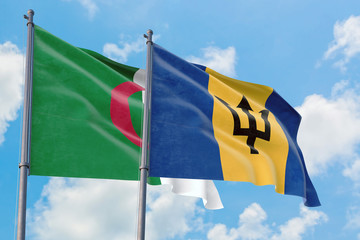 Barbados and Algeria flags waving in the wind against white cloudy blue sky together. Diplomacy concept, international relations.
