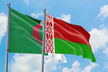 Belarus and Algeria flags waving in the wind against white cloudy blue sky together. Diplomacy concept, international relations.