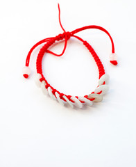 Happy ethnic red thread on a hand with jade coins on a white background, view from above,  with copy space