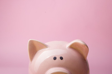 Piggy bank and golden coin. Savings and finance concept