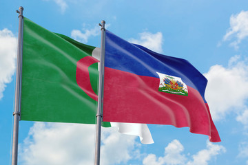 Haiti and Algeria flags waving in the wind against white cloudy blue sky together. Diplomacy concept, international relations.