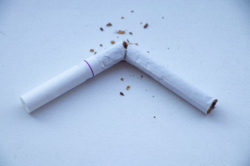 Nicotine addiction - stop killing yourself. Fist on cigarette butts. Broken cigarette in the hands....