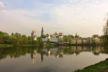Fototapeta na wymiar Novodevichy monastery in sunny weather with reflections in summer evening, Moscow, Russia