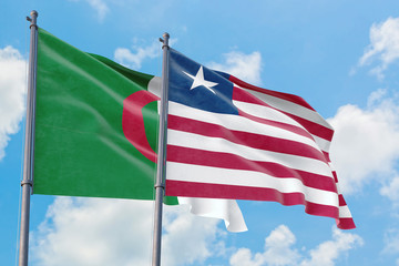 Liberia and Algeria flags waving in the wind against white cloudy blue sky together. Diplomacy concept, international relations.