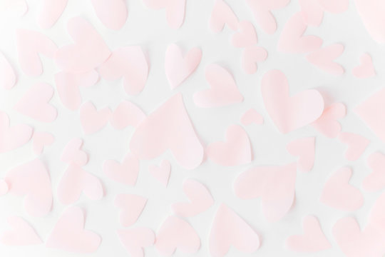 Cute pink pastel hearts on white paper  background. Flat lay. Happy valentines day. Pink paper heart cutouts on white backdrop, gentle image, greeting card. Valentine pattern
