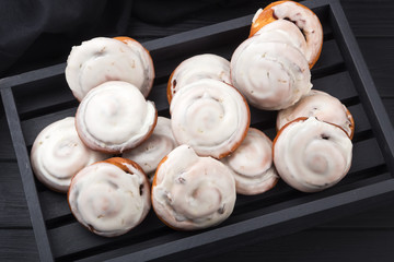 Puff curls with fruit, jam, berries on a black table with a blue napkin. Puff pastry on a wooden board and a black wooden table. Fresh French Homemade Puff curls pastry. Warm Fresh Buttery Rolls.