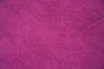  The texture of natural suede. Purple background of leather material.