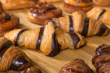 Different kinds of fresh bread on a table. Assortment of fresh bakery products on wooden table.