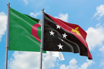 Papua New Guinea and Algeria flags waving in the wind against white cloudy blue sky together. Diplomacy concept, international relations.