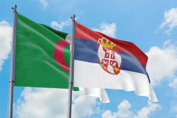Serbia and Algeria flags waving in the wind against white cloudy blue sky together. Diplomacy concept, international relations.