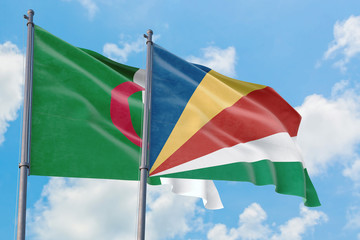 Seychelles and Algeria flags waving in the wind against white cloudy blue sky together. Diplomacy concept, international relations.