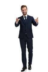 enthusiastic businessman smiling and pointing fingers
