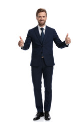 smiling young businessman making thumbs up sign