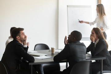 Multi-ethnic corporate staff yawning taking part in boring seminar
