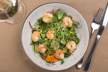 Shrimp salad, lettuce, cucumber, spinach olive oil. fresh healthy shrimps salad. Close up view on Salad. Healthy, diet tasty summer dish