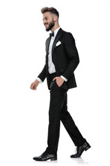 businessman walking with one hand in pocket on his way