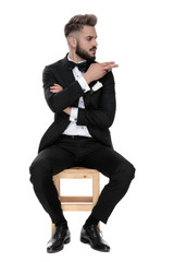 businessman sitting and giving aside a cut it out sign