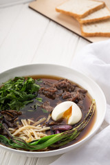 Asian ramen noodle soup with vegetables. Asian noodle soup, ramen with vegetables and egg. Indo-chinese cuisine hot dish with vegetables and chilli sauce. 